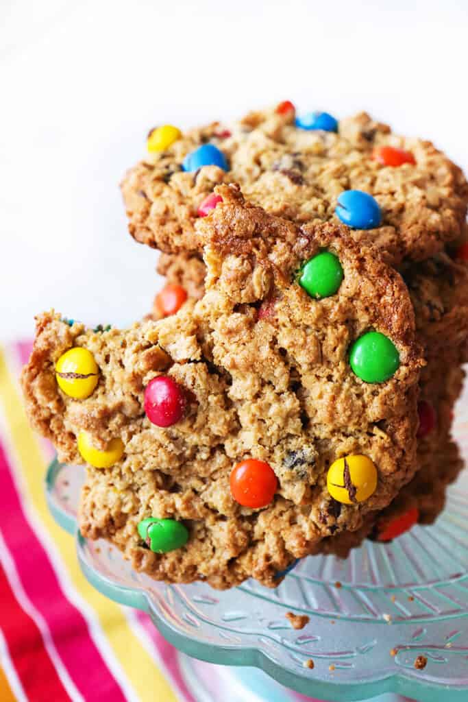 stack of monster cookies with one cookie missing a bite