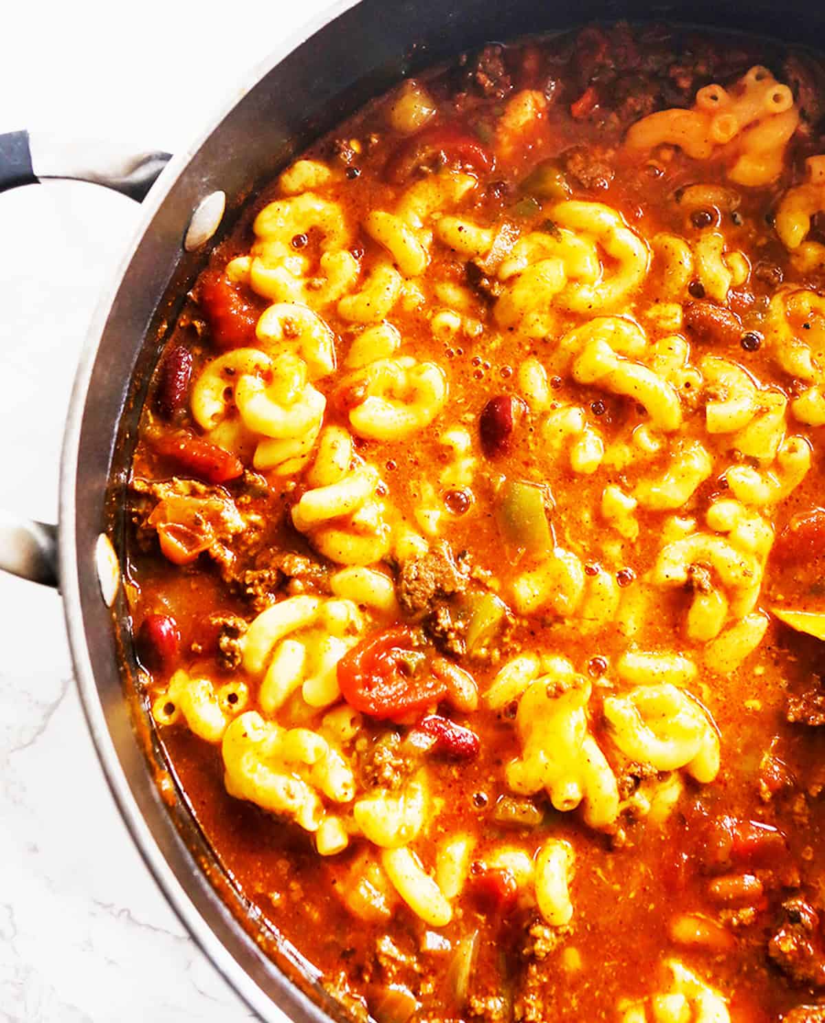 Top view of comforting pan filled with macaroni and cheese combined with chili.