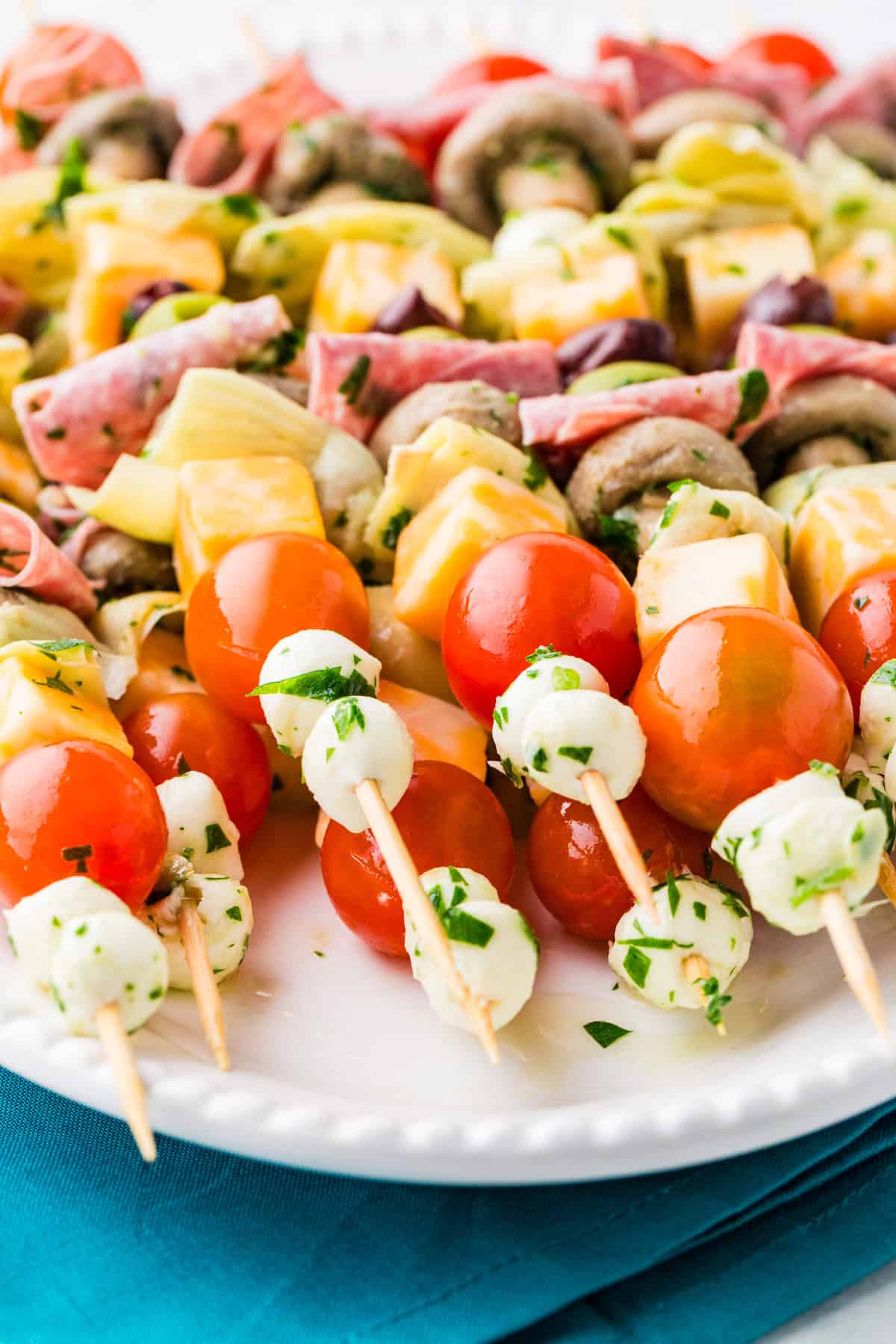 Close up of loaded finger food skewers on a serving platter.