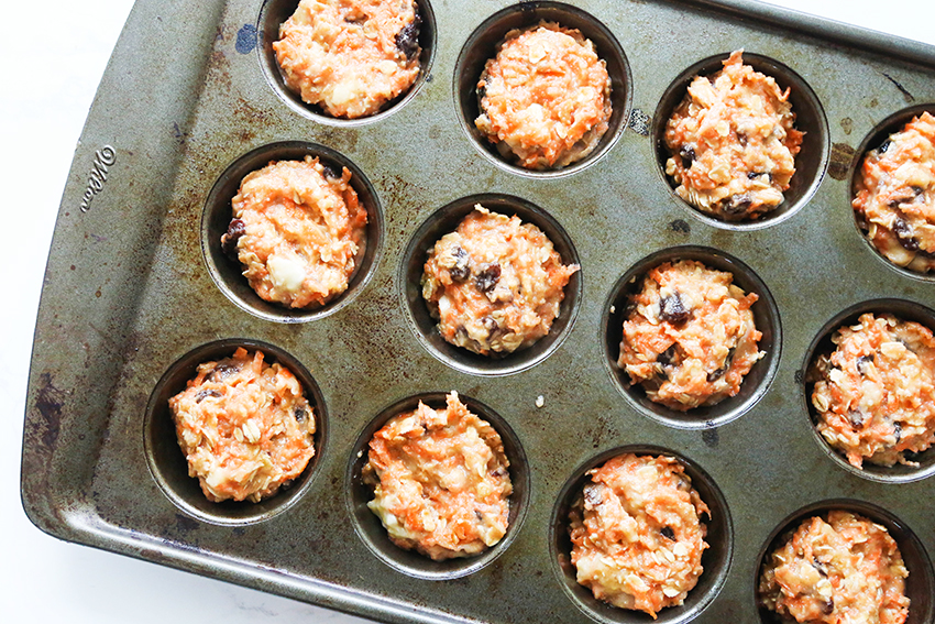 muffin tin filled with batter for healthy breakfast muffins
