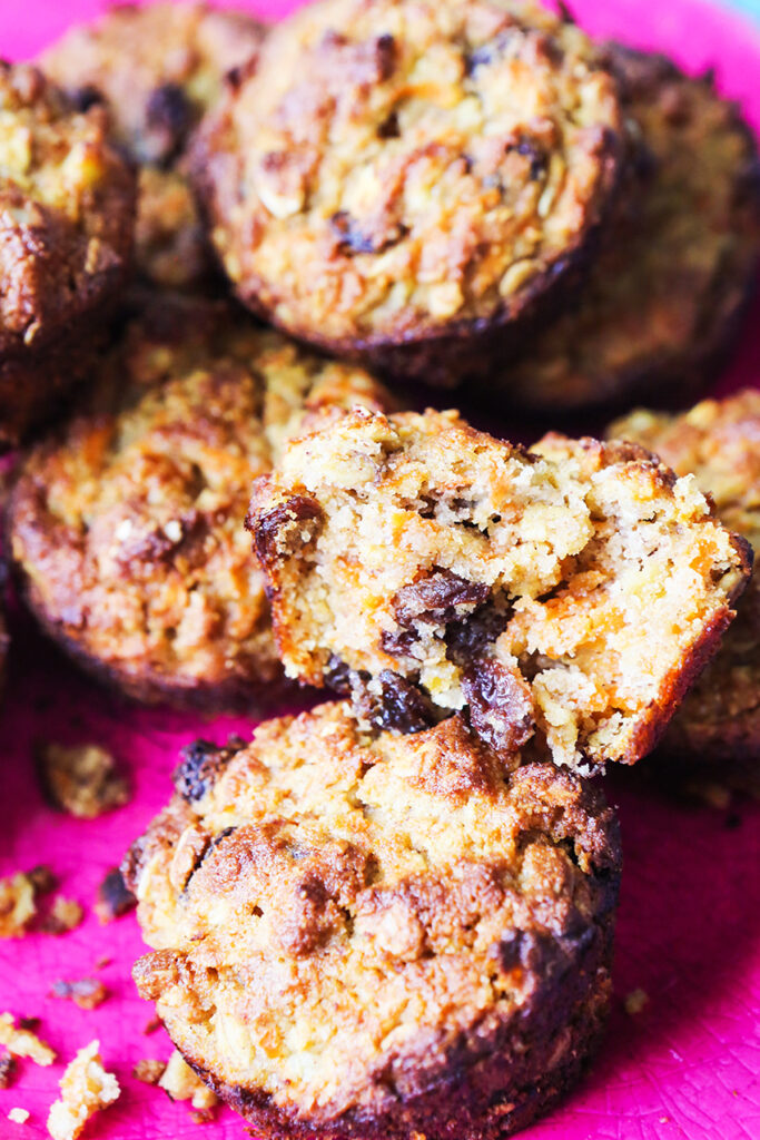 healthy breakfast muffins stacked on a pink serving plate