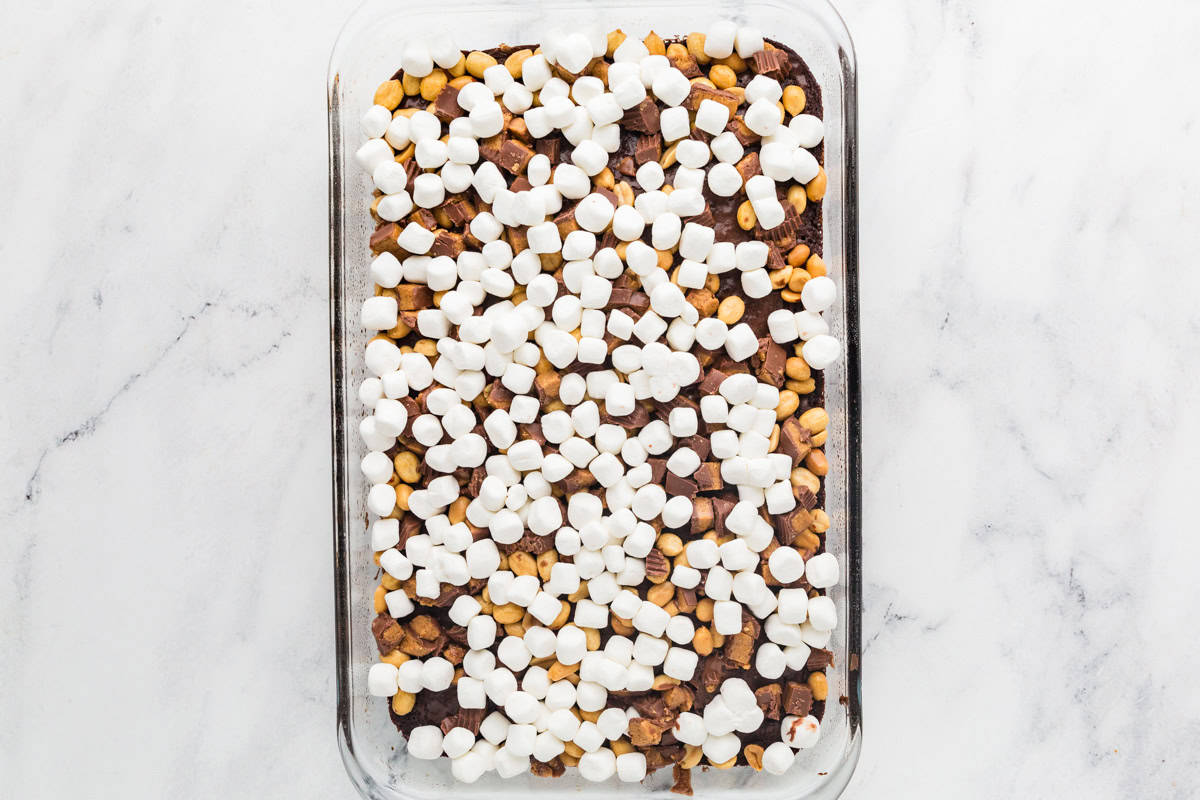 Brownies in pan, topped with peanut butter cups and marshmallows.