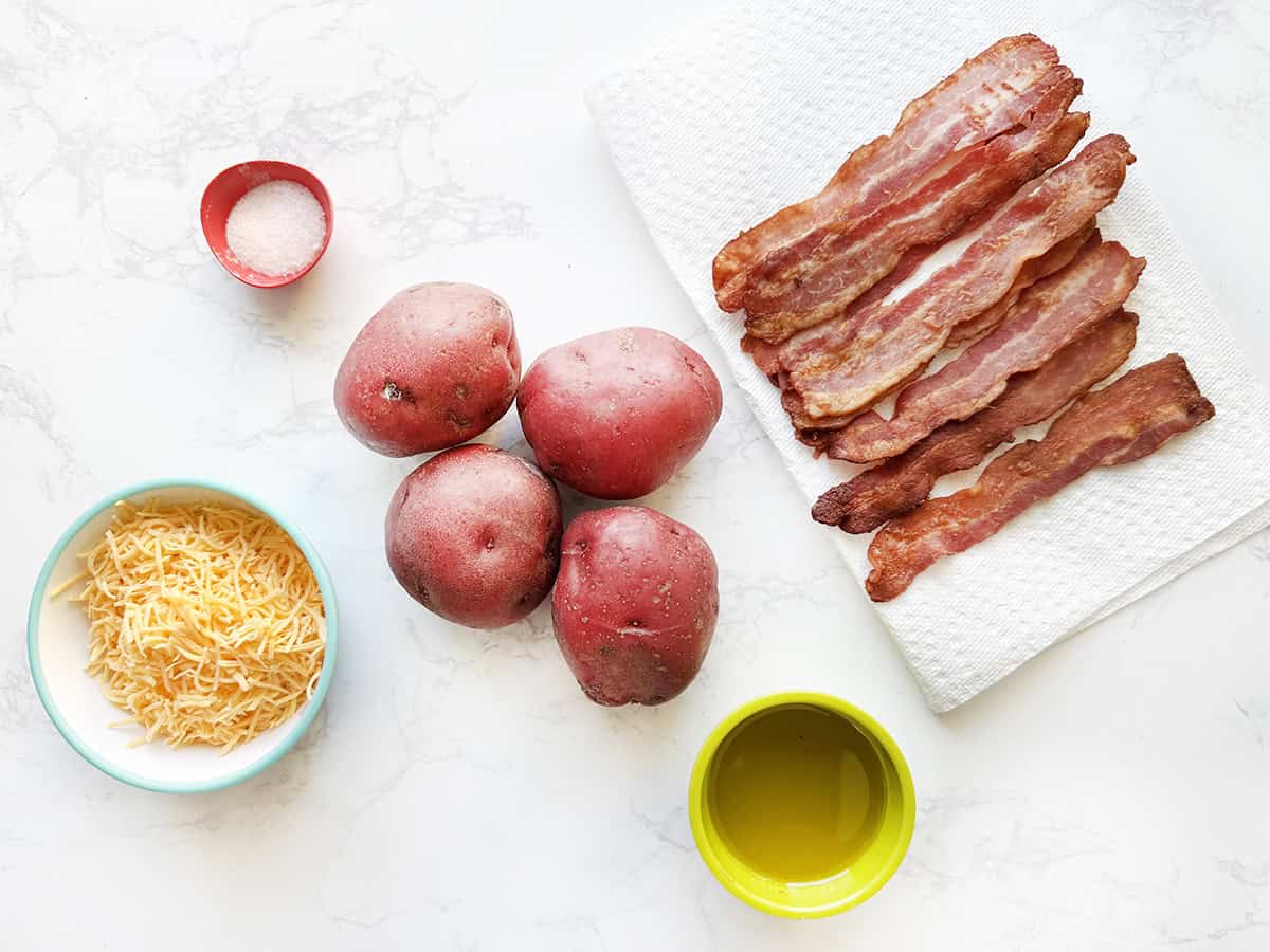 Ingredients for baked potato rounds lined up on a white counter.