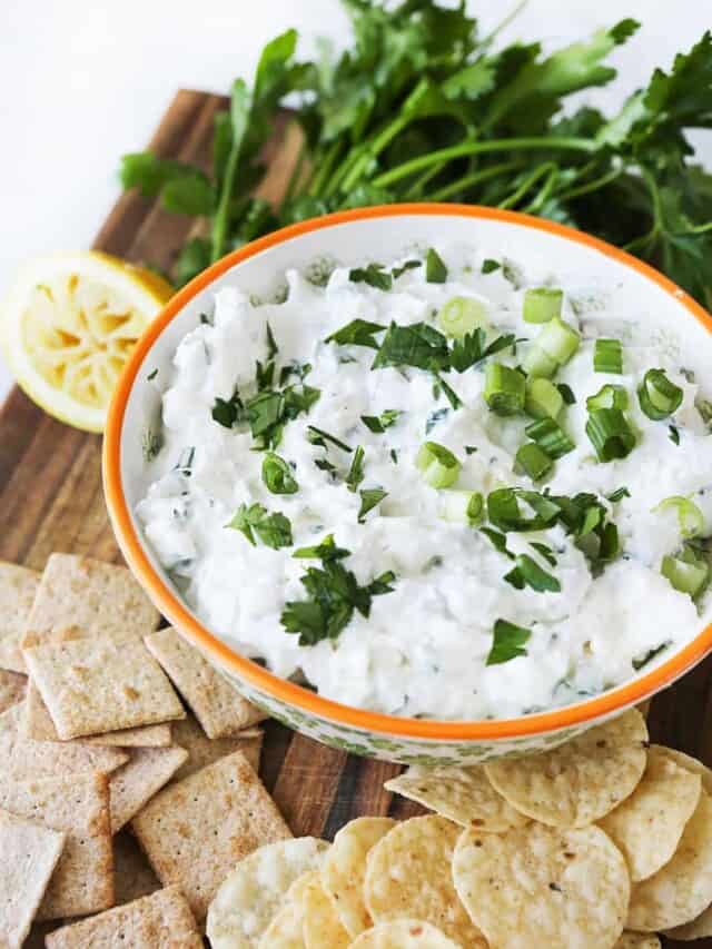 Feta Dip in a bowl with crackers and chips around it. 