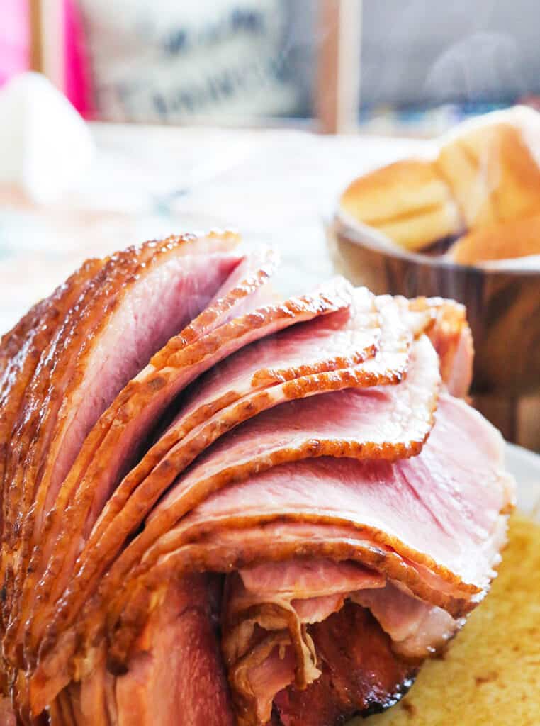 sliced ham in a serving dish on a table