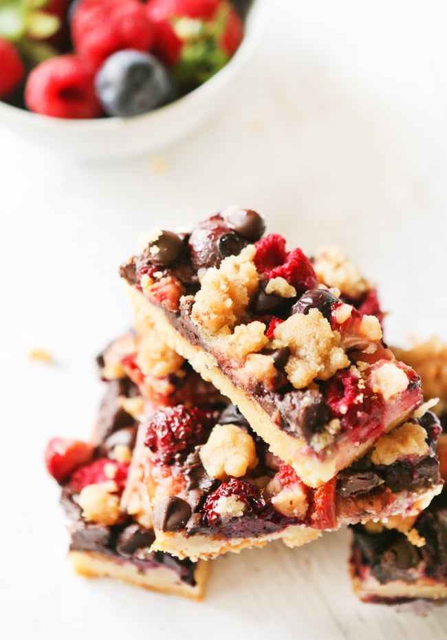 crumble bars loaded with berries and stacked on a counter