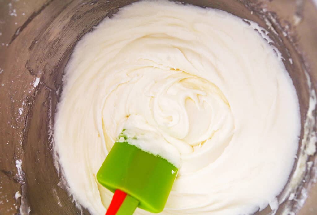 cream cheese frosting in mixing bowl with spatula