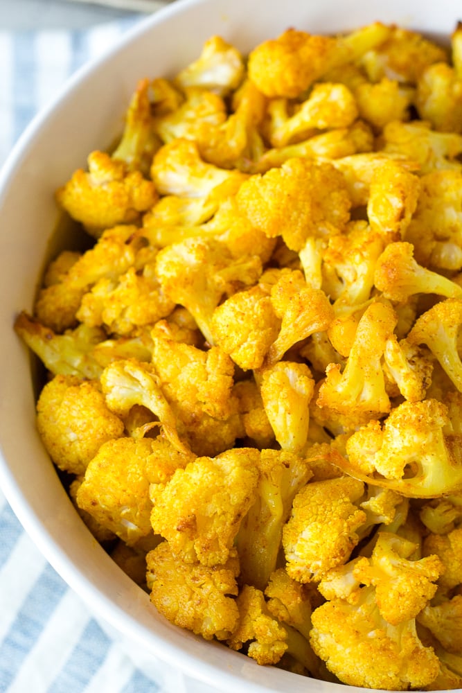 turmeric roasted cauliflower in a white serving bowl