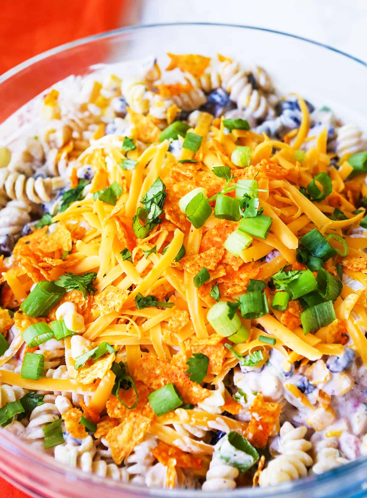 close up of a bowl full of taco pasta salad covered with doritos