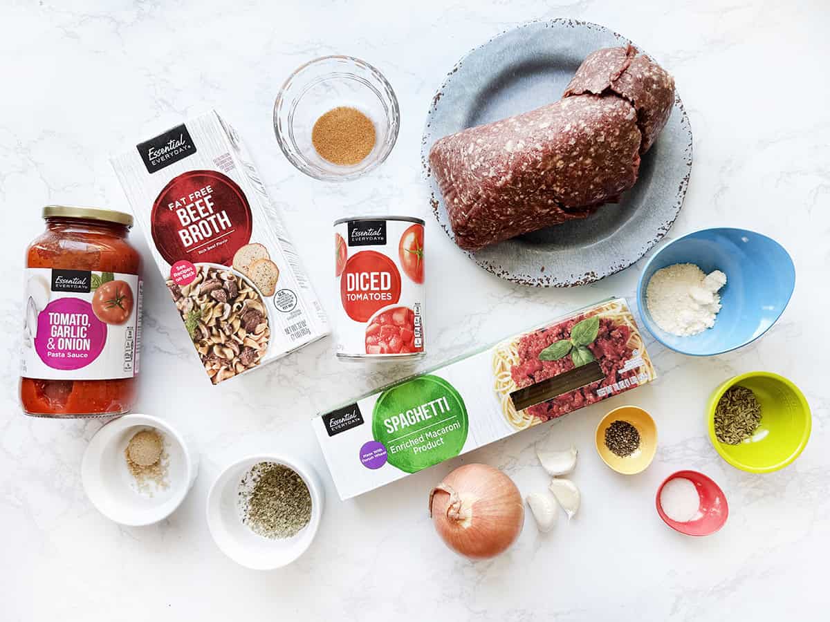 Ingredients for Instant Pot Spaghetti with Meat Sauce lined up on a white counter.