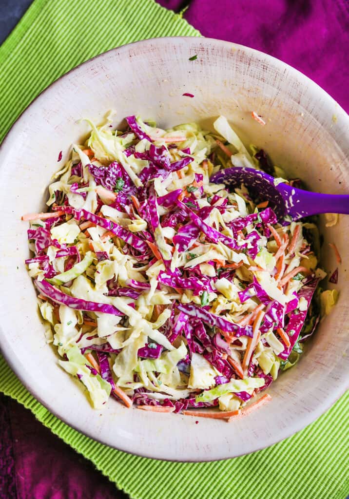 Serving bowl of coleslaw with apple cider vinegar. 