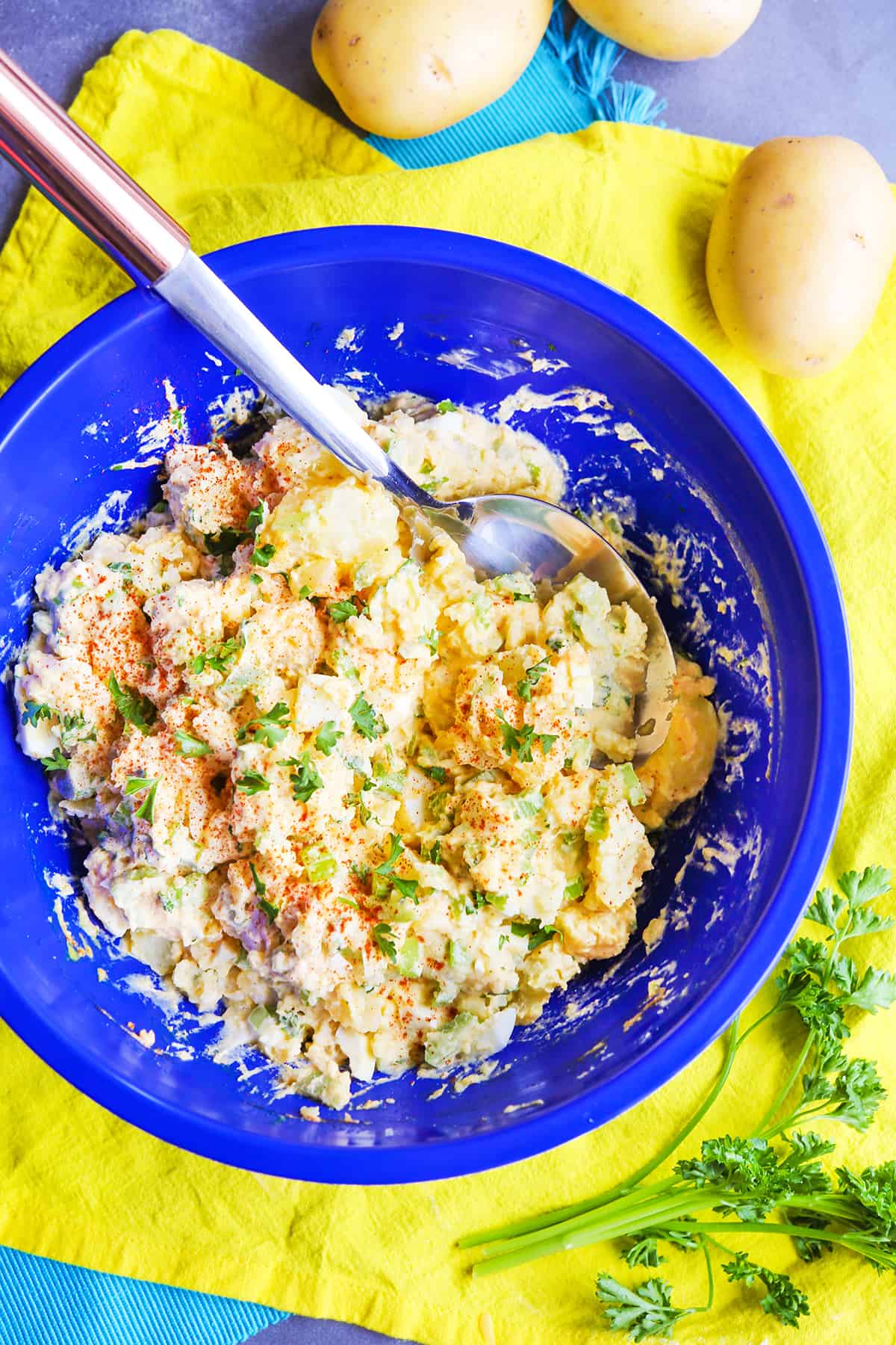 Blue mixing bowl filled with potato salad.