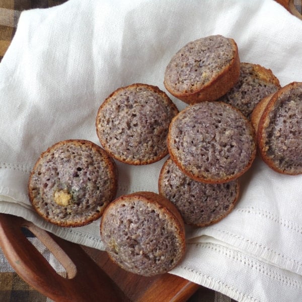 blue cornbread muffins sitting inside a decorative towel 