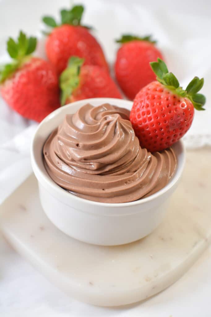 chocolate mousse in a cup with a whole strawberry as a garnish
