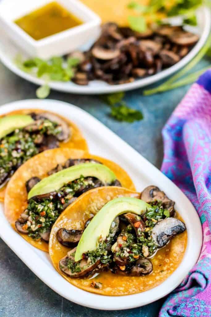 3 corn tortillas mushroom tacos drizzled with chimichurri sauce