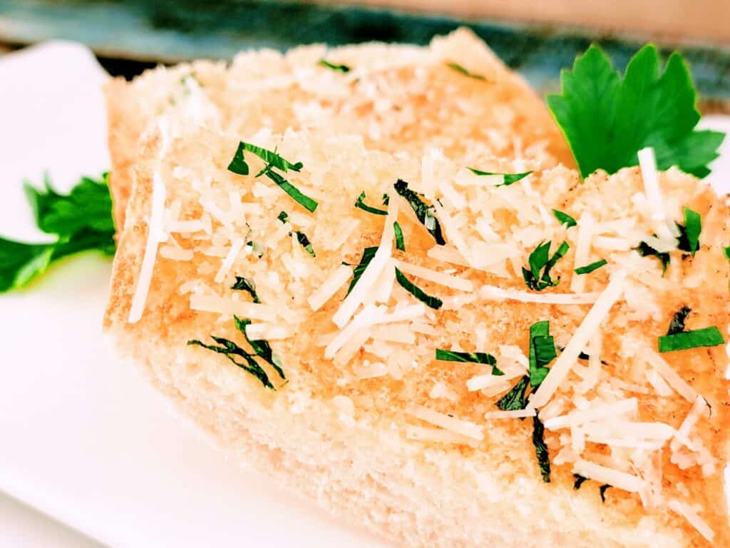 slice of garlic bread and parsley sprinkled on top