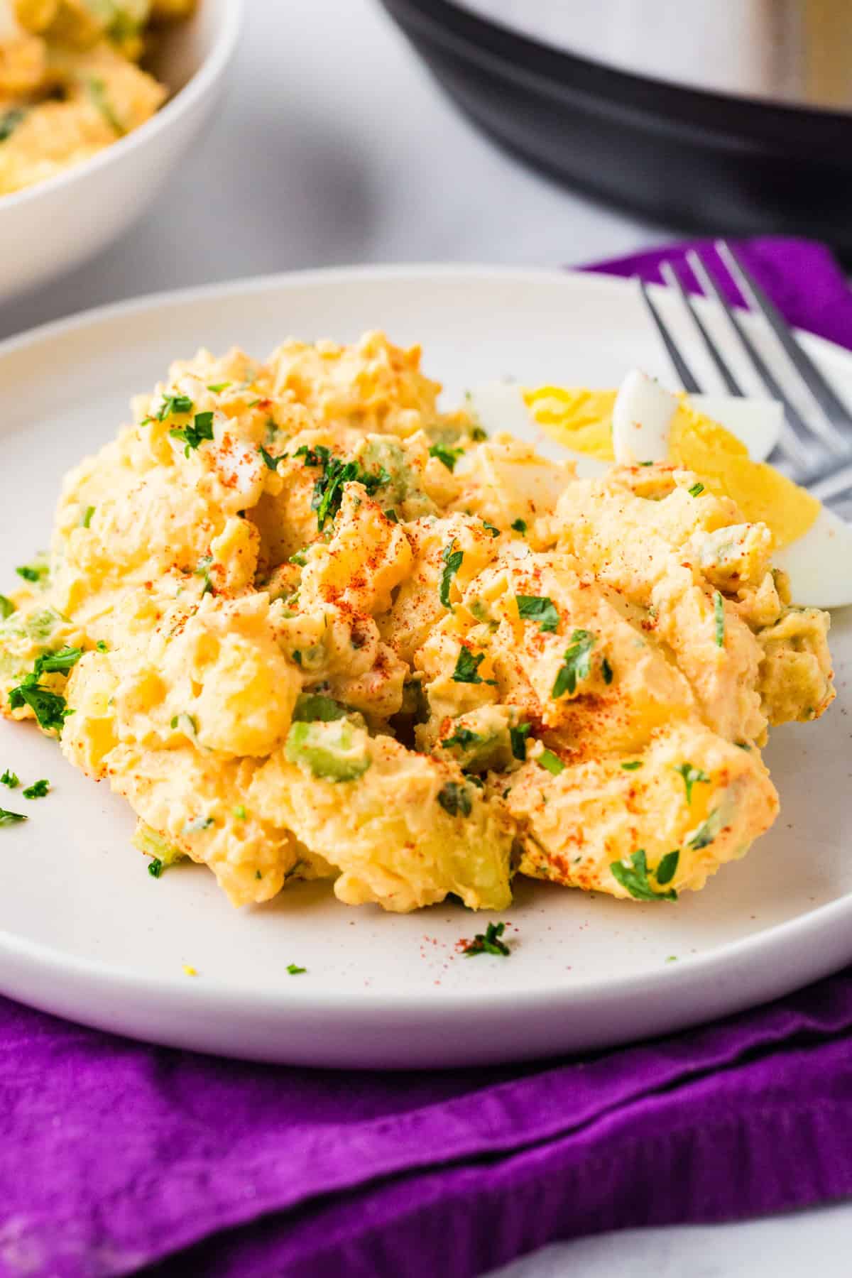 Plate of potato salad next to an Instant Pot.