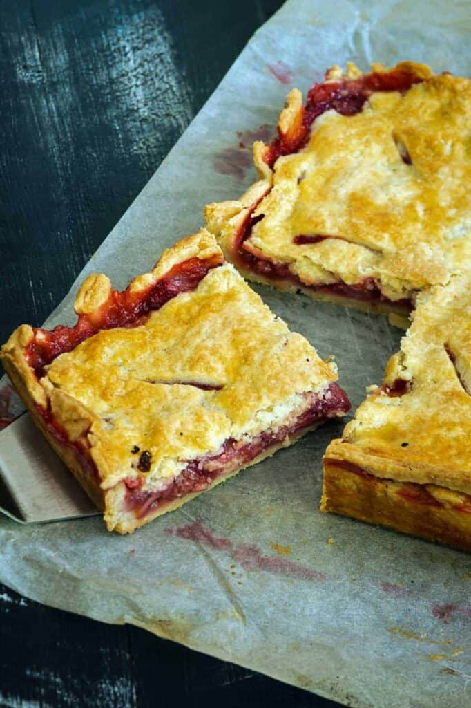 several slices of strawberry slab pie on parchment paper