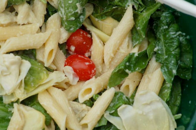 pasta mixes with cherry tomatoes and spinach