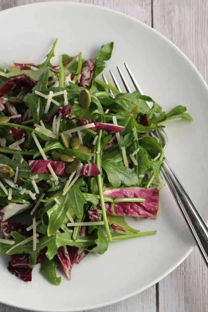 plate of arugula salad with maple vinaigrette