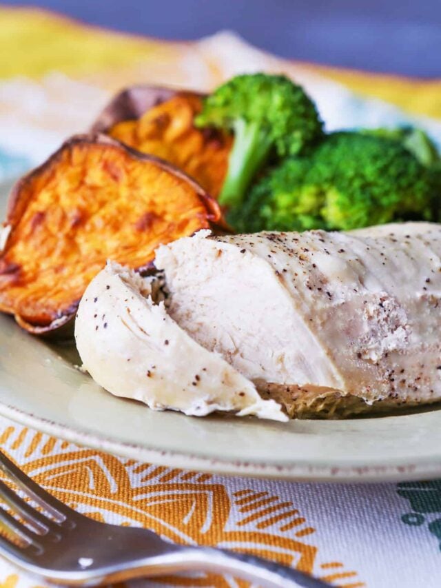 Instant pot grilled chicken served on a plate with broccoli and sweet potatoes. 