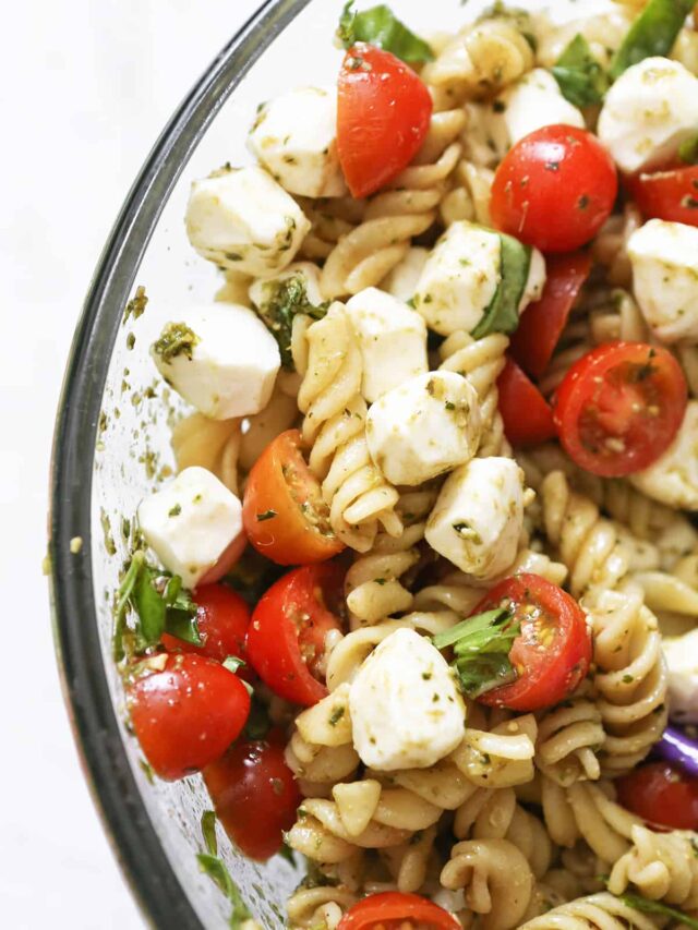 Glass bowl of caprese pasta salad. 