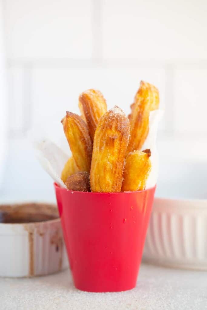 air fryer homemade churros standing up in a bowl