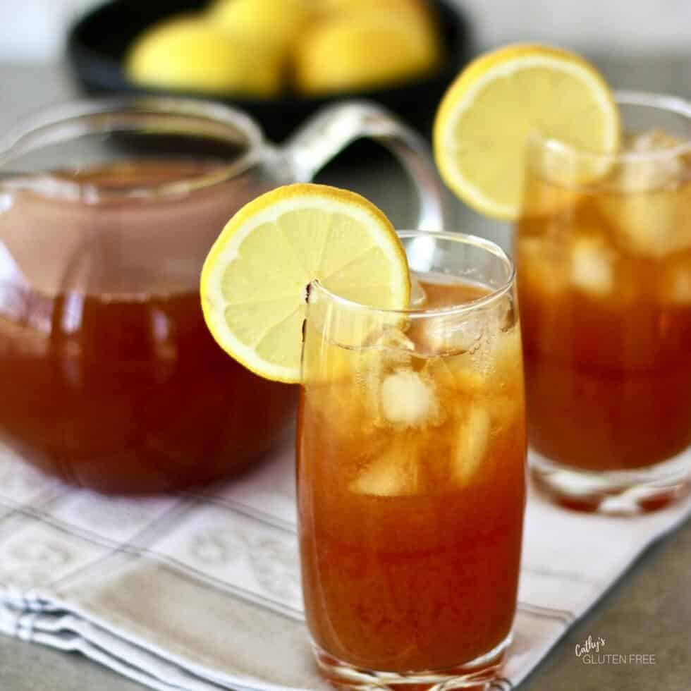 2 glasses of iced lemon tea with raw honey and fresh juice and a lemon garnish