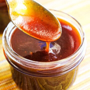 Close-up of homemade BBQ sauce being spooned from a jar.