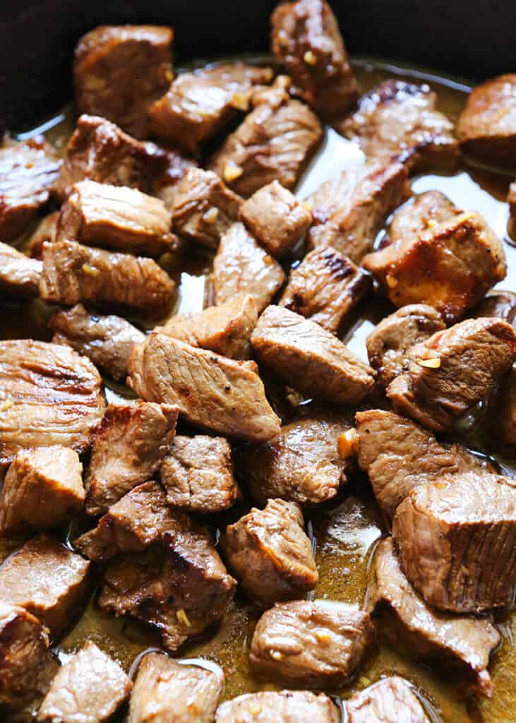 small pieces of steak in a skillet