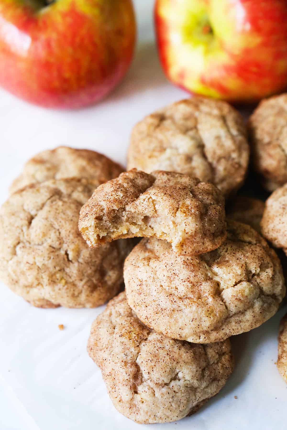 Pile of apple snickerdoodle cookies covered in sugar and cinnamon.
