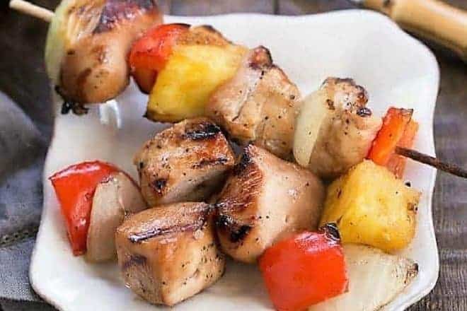 What To Serve With Corn On The Cob. Pieces of honey glazed chicken kabobs with onion, red pepper and onion pieces removed from a skewer and sitting on a plate. 
