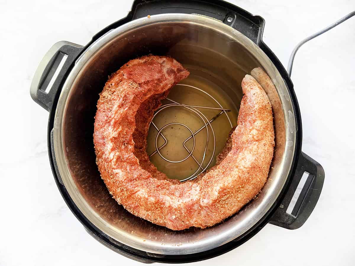 Ribs bent into a circle inside an Instant Pot.