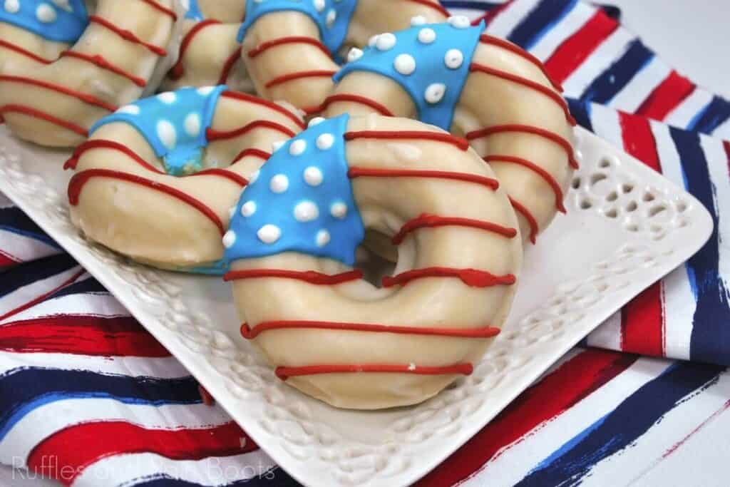 Patriotic flag donuts layered on top of a plate. 