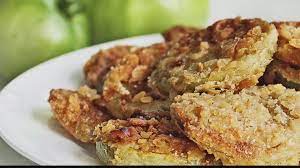 Plate of fried green tomatoes stacked on top of one another. 