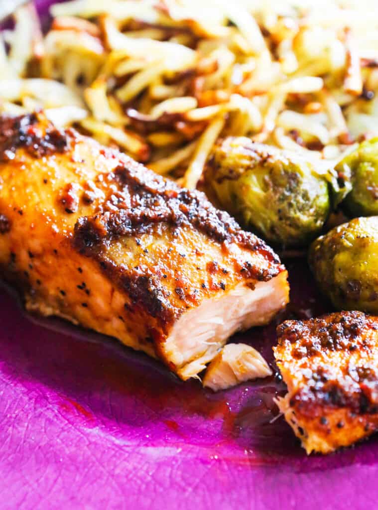 Air fried salmon on a plate served with Brussels sprouts and hashbrowns. 