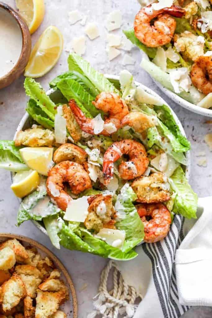 Shrimp caesar salad placed in a bowl ready to eat. 