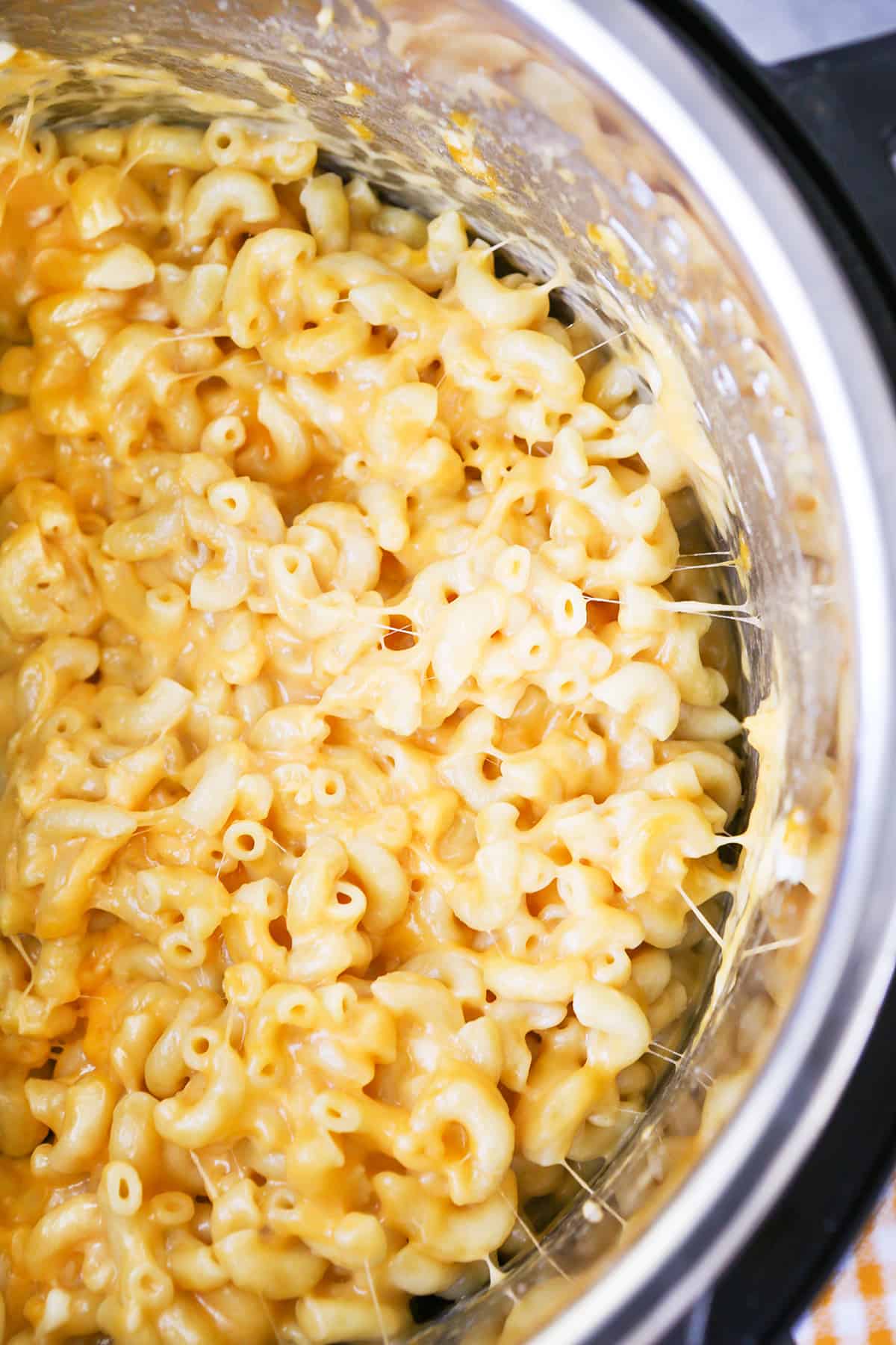 Top view of a pot filled with gooey mac and cheese.