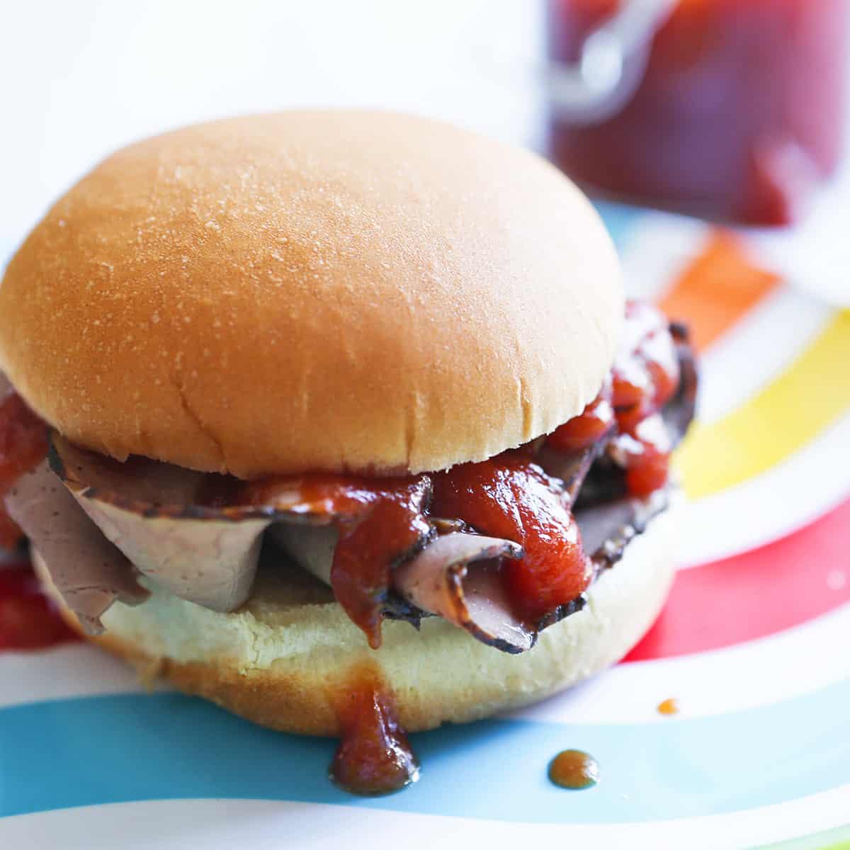 Arby's Roast Beef Sandwich with the famous sauce dripping out the sides.