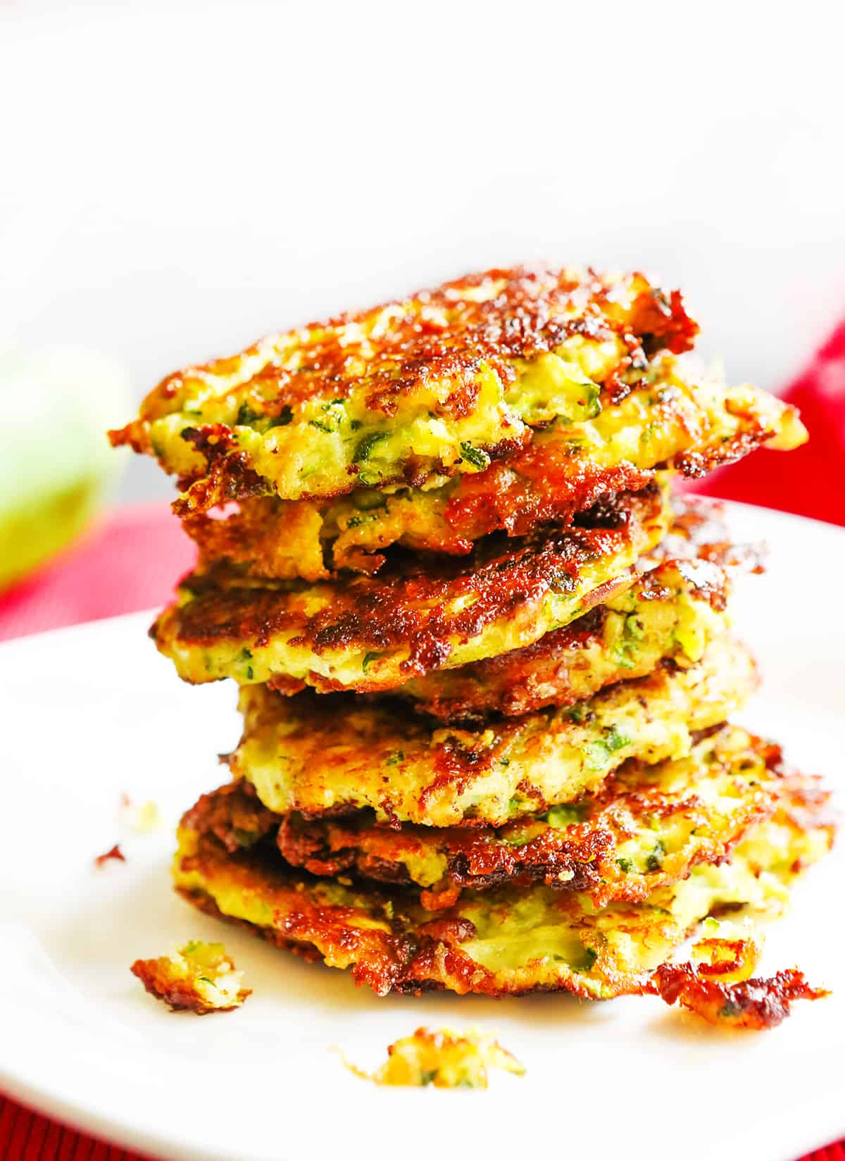 Stack of zucchini fritters on a plate. 