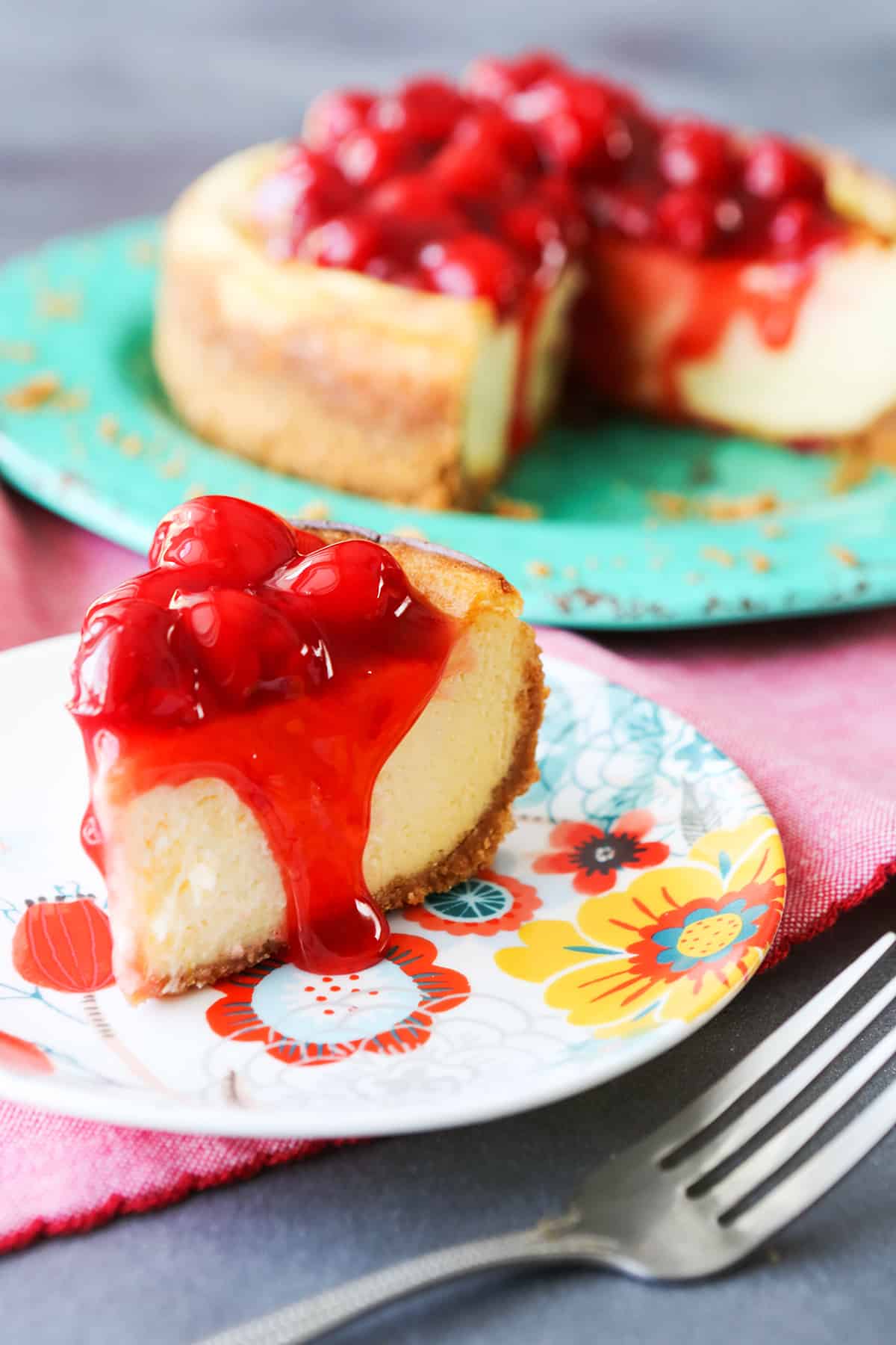  Slice of cherry cheesecake on a plate.