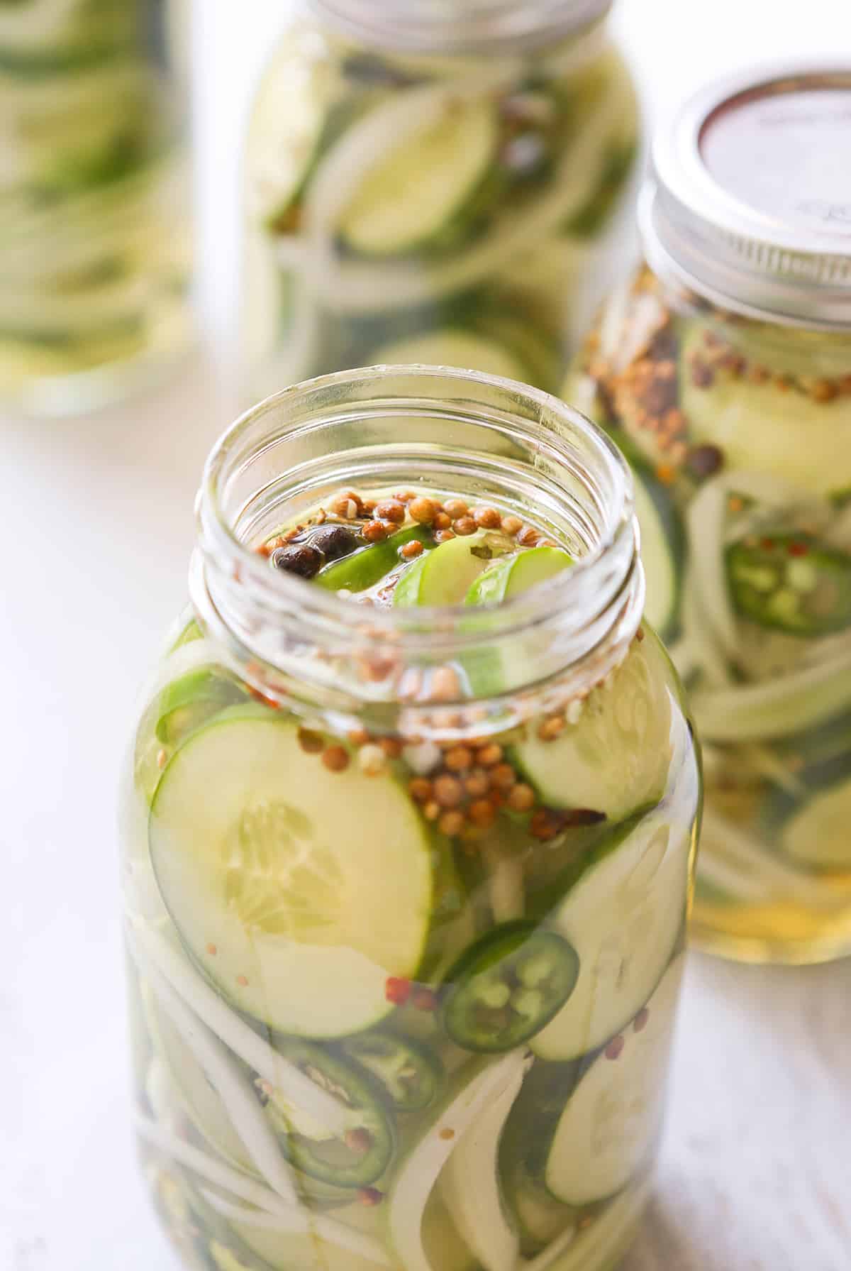 Mason jar full of refrigerated sweet pickles.