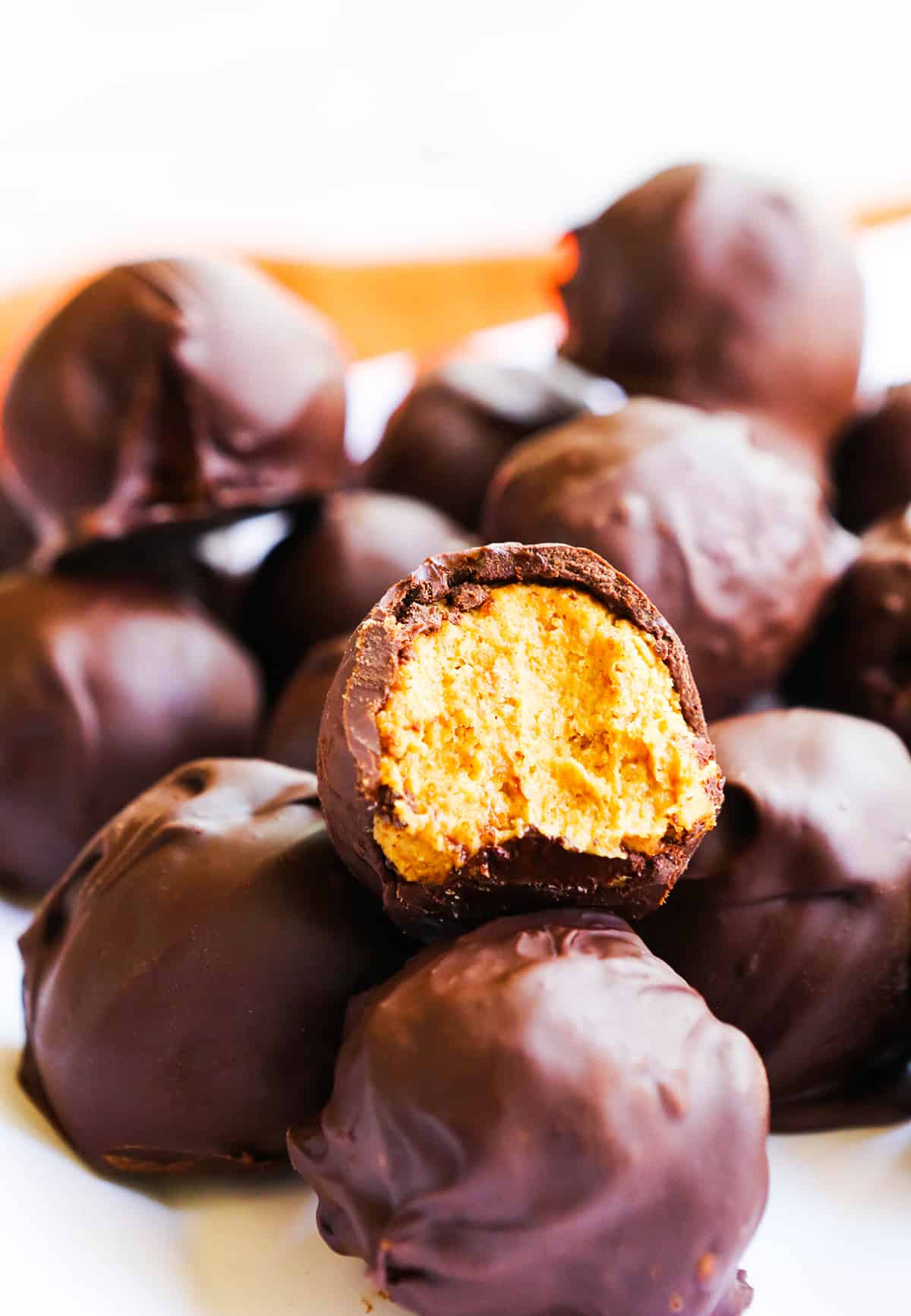 delicious pumpkin being exposed inside a chocolate truffle.