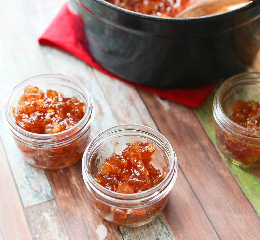 Two small glass jars of apple pie jam without pectin. 