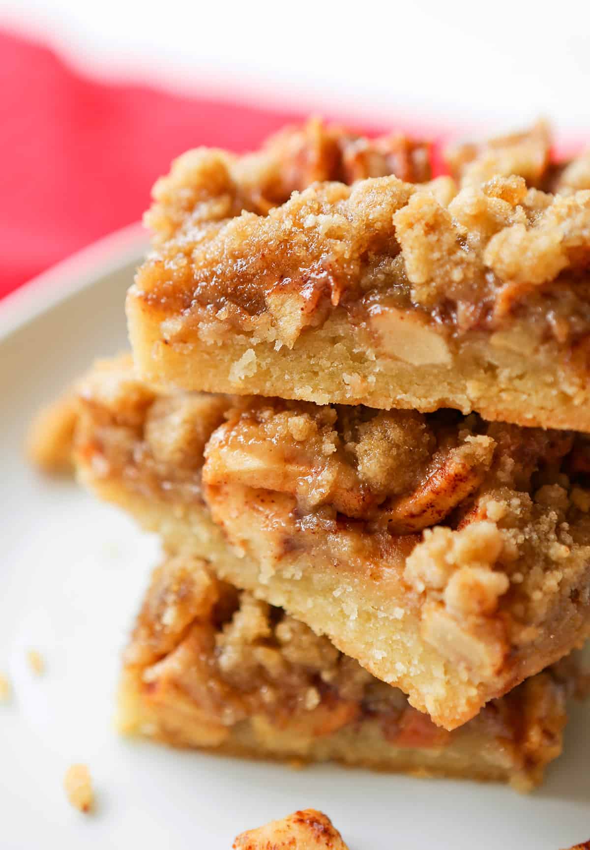Stack of apple pie bars on a serving plate.