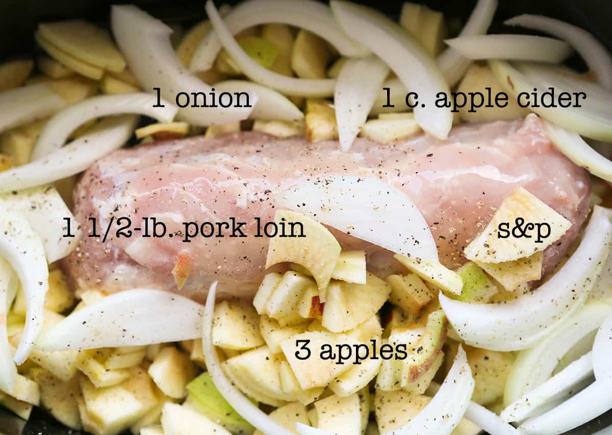 Pork loin, apples and onions in a crockpot ready to cook.