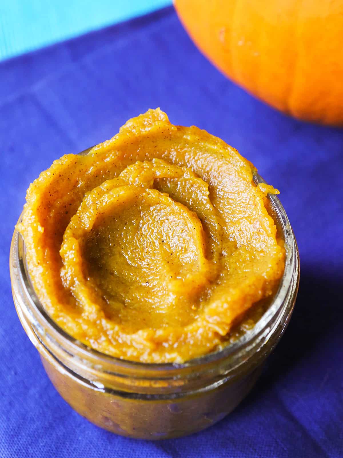  jar of INSTANT POT pumpkin puree on a blue placemat.