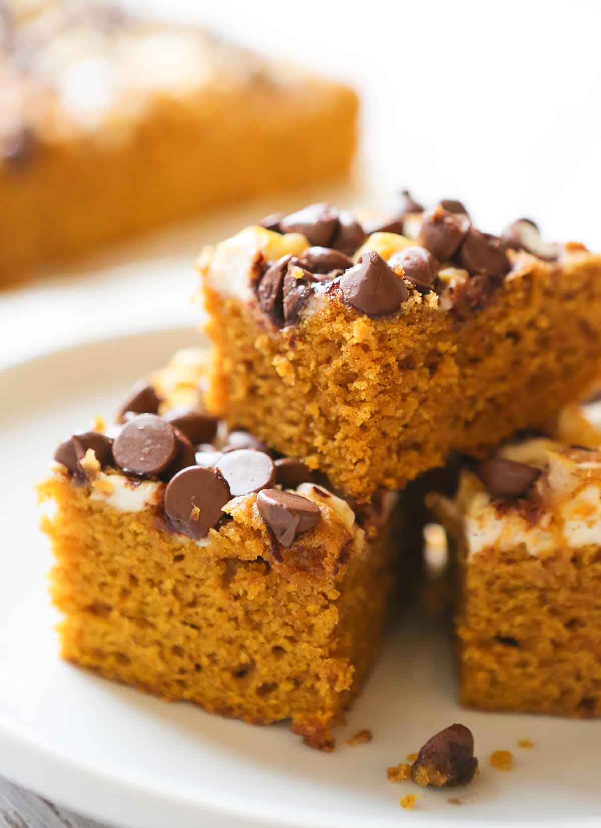 Stacked pumpkin cake with chocolate chips on top.