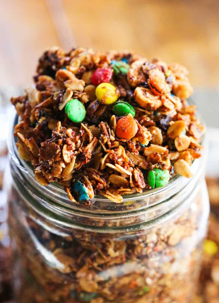 candy granola spilling out of a large mason jar.