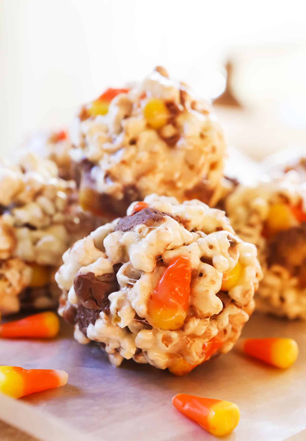 stack of popcorn balls with chopped halloween candy inside.